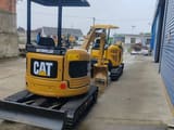2022 Caterpillar 303E mini excavator, rear three-quarter view