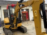 2023 Caterpillar 303CR mini excavator, front three-quarter view