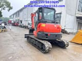 2023 Kubota KX057-4 mini excavator, rear three-quarter view