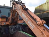 1990 O&K MH 5 wheel excavator, side view of boom and cab