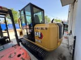 2024 Caterpillar 305.5E2 mini excavator, rear three-quarter view