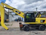 2011 Caterpillar M318D MH material handler, side view
