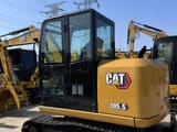 2024 Caterpillar 305.5 mini excavator, rear three-quarter view