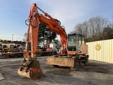 2004 Kobelco E145W wheel excavator, front three-quarter view