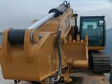 2025 Caterpillar 323D3 crawler excavator, front-facing boom view