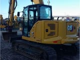 2021 Caterpillar 310-07 crawler excavator, rear three-quarter view