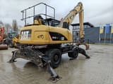 2010 Caterpillar M318D MH demolition excavator rear three-quarter view