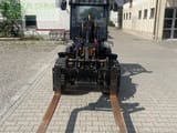 2022 JCB 403 mini excavator, front view with pallet forks