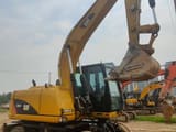 2023 Caterpillar M315D wheel excavator, side profile view