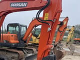 2023 Doosan DX60-9C mini excavator, front three-quarter view