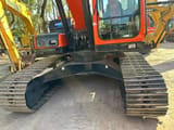 2023 Doosan DX225LC excavator, front view of the undercarriage and cab
