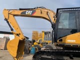 2010 Caterpillar 320D rupsgraafmachine zijaanzicht