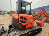 2024 Kubota U55-4 mini excavator, rear three-quarter view