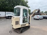 1995 Schaeff HR 12 mini excavator, rear three-quarter view