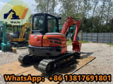 2024 Kubota KX057-4 mini excavator, rear three-quarter view