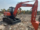 2022 Doosan DH55 mini excavator, front three-quarter view