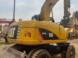 2023 Caterpillar M315D wheel excavator, rear three-quarter view