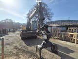 2005 Volvo EW140B wheel excavator, front view with grapple attachment