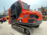 2023 Doosan DX80 mini excavator, rear three-quarter view