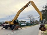 2011 Caterpillar M325D material handler side view
