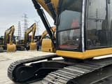 2023 Caterpillar 320 excavator, side view of cab and tracks