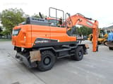 Doosan DX210W wheel excavator, rear three-quarter view