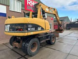 2003 Caterpillar M315C wheel excavator, rear three-quarter view