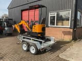 JPC HT-12 mini excavator on trailer, rear three-quarter view