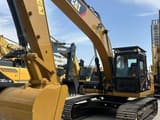 2009 Caterpillar 323DL crawler excavator, front three-quarter view