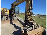 2009 Caterpillar M318D wheel excavator, front three-quarter view