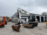 2010 Caterpillar M316D wheel excavator, front three-quarter view
