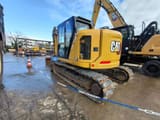 2023 Caterpillar 315 crawler excavator, rear three-quarter view