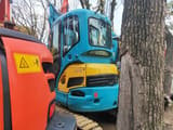 2023 Kubota KX135-3S mini excavator, front three-quarter view