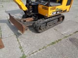 2018 JCB 15C-1 mini excavator, front-side view of tracks and blade