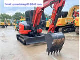 2023 Kubota KX057-4 mini excavator, rear three-quarter view