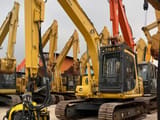 2021 Komatsu PC120 crawler excavator with tree shear attachment, front three-quarter view