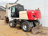 2011 Caterpillar M316D wheel excavator, rear three-quarter view