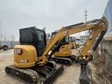2024 Caterpillar 303.5E mini excavator, front three-quarter view