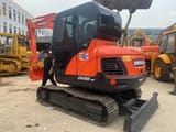 2023 Doosan DX55-9C mini excavator, front three-quarter view