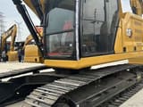 2023 Caterpillar 320 excavator, side view of cab and tracks