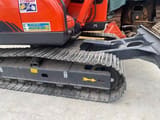 2023 Doosan DX80 mini excavator, side view of undercarriage and blade