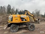 2011 Caterpillar M313D wheel excavator, rear three-quarter view