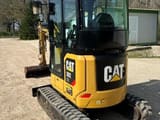 2019 Caterpillar 302 NG mini excavator, rear three-quarter view