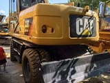 2019 Caterpillar M315D wheel excavator, rear three-quarter view