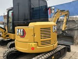 2024 Caterpillar 303.5ECR mini excavator, rear three-quarter view