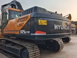 2024 Hyundai 305LC-9T crawler excavator, rear three-quarter view