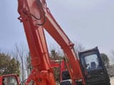 Hitachi ZX120 crawler excavator, low angle view of boom and cab