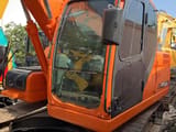 2023 Doosan DX140LC crawler excavator, side view of the cab