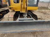 Komatsu PC56 mini excavator front view with blade
