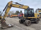 2010 Caterpillar M318D wheel excavator, front three-quarter view